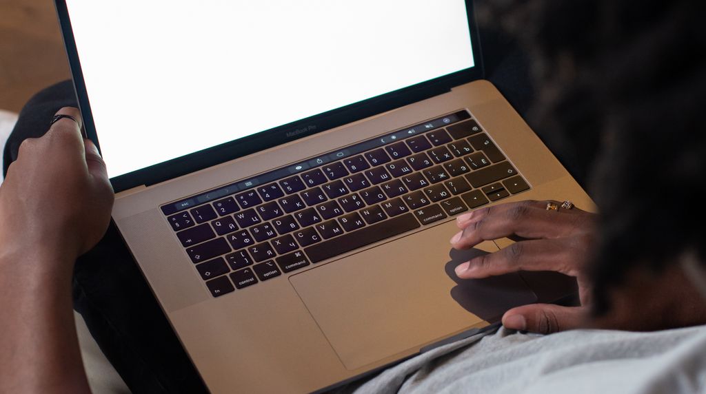 Looking over someone's shoulder as they read a website on a laptop